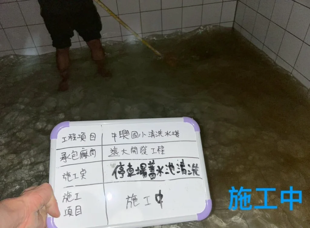 中興國小蓄水槽施工中,人員站在槽內刷洗底部與內壁